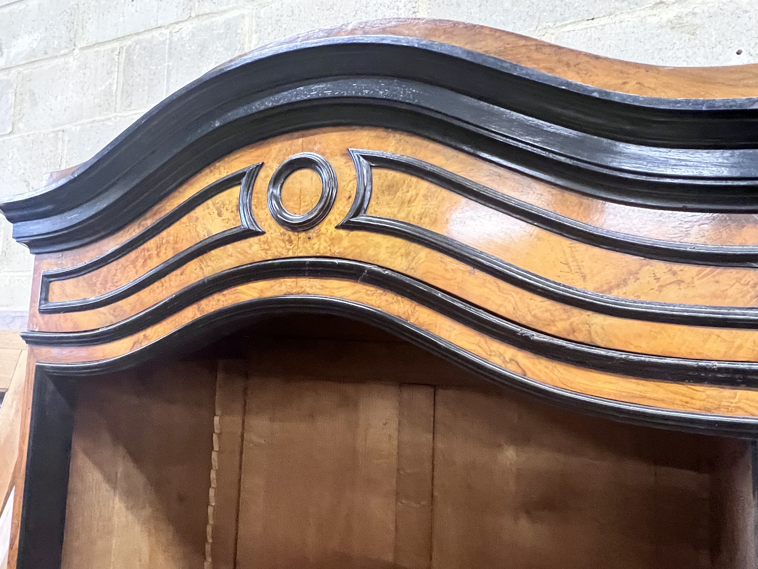 A 19th century French walnut and ebonised armoire, width 107cm, height 225cm